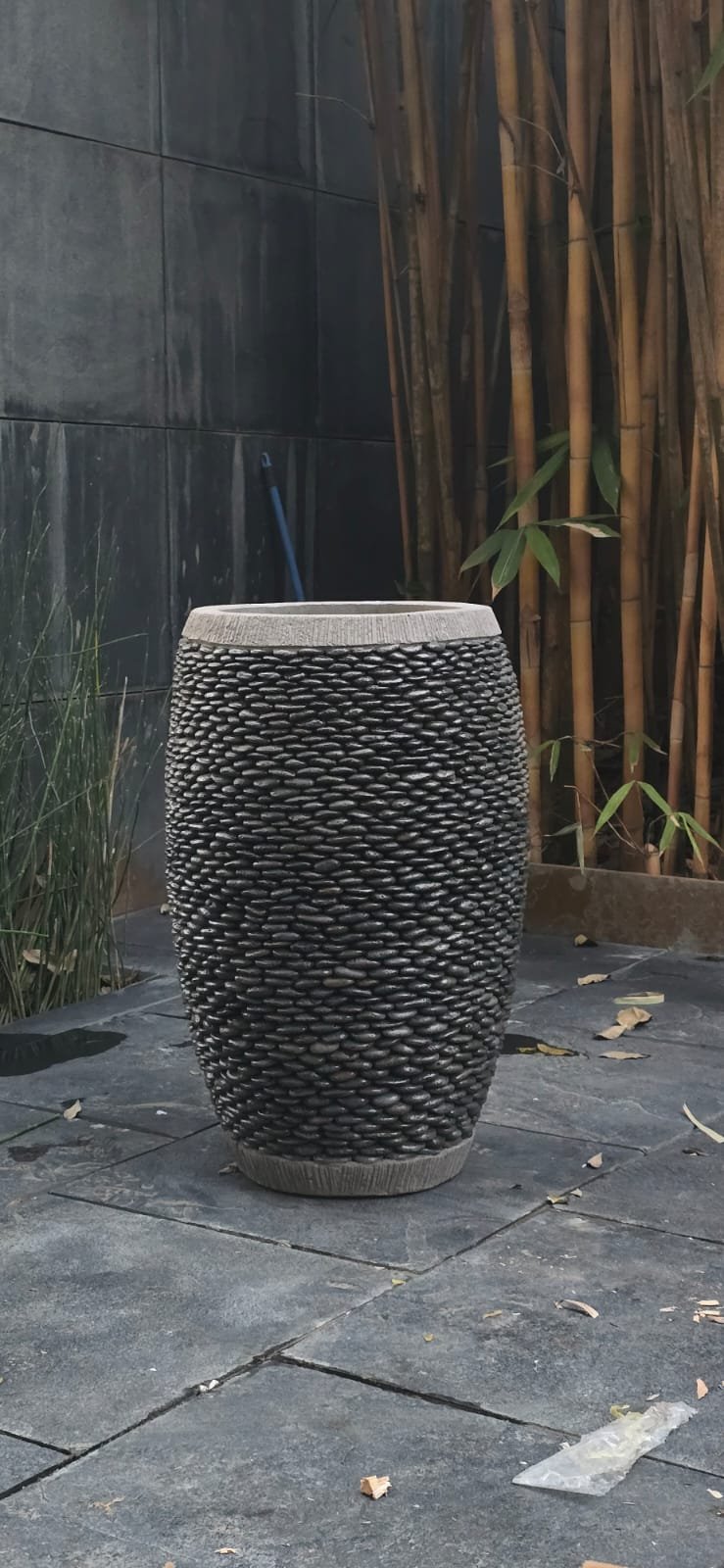 Tall pebble-textured stone planter
