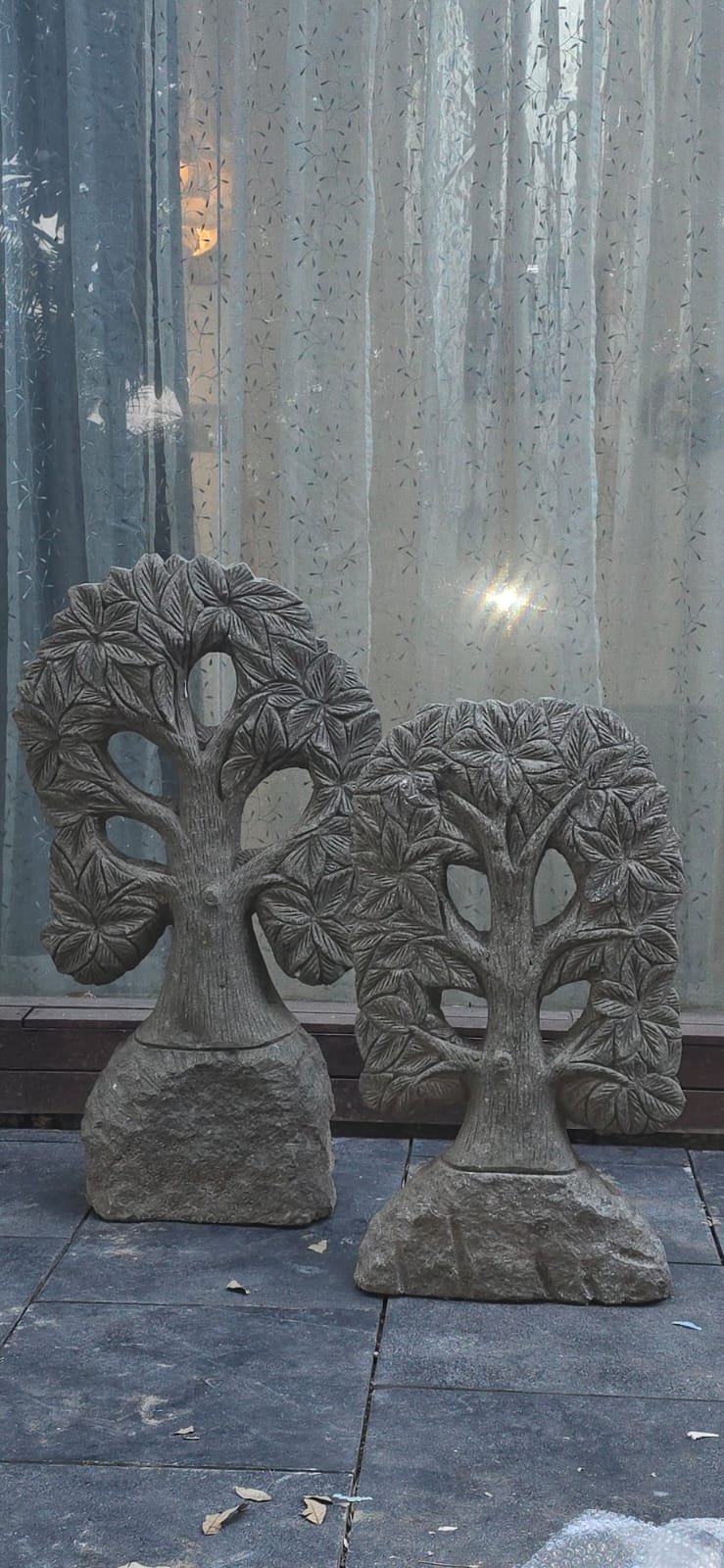 Carved stone tree-of-life garden plaques